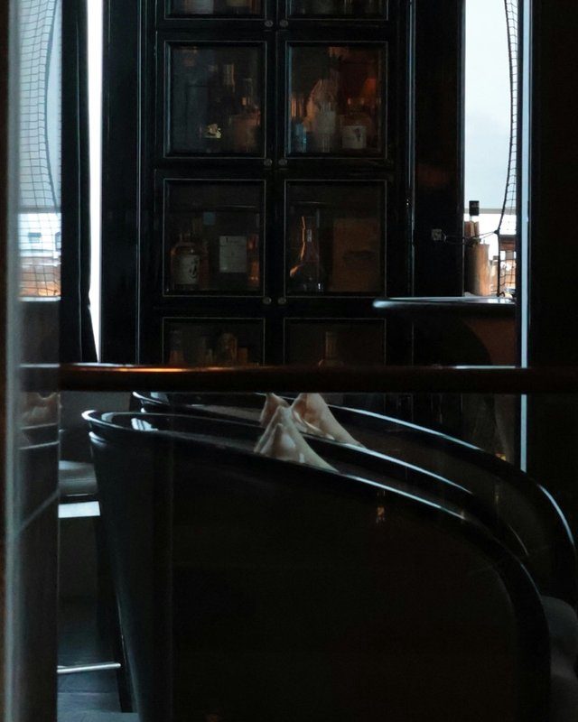 A dark, quiet corner of a five star hotel bar