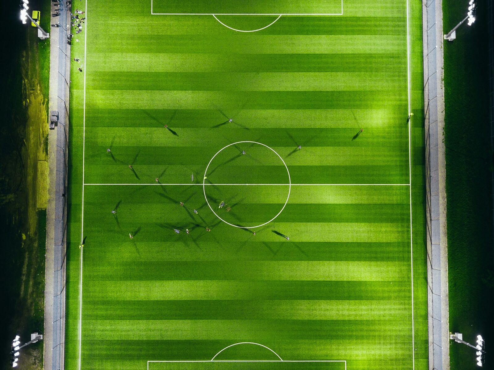 A floodlit football pitch seen from above at night